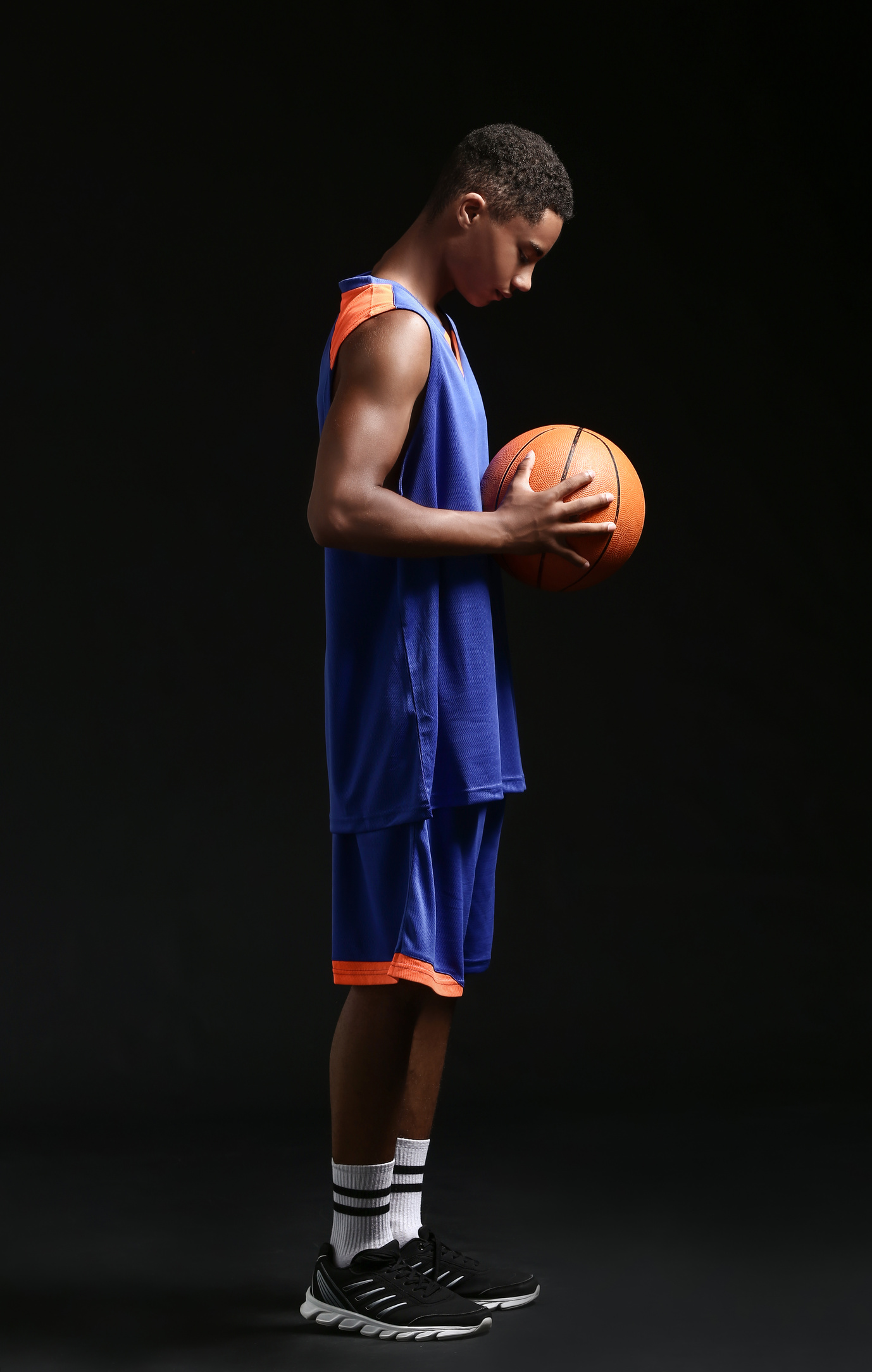 Young Basketball Player on Dark Background